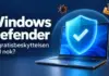 Windows Defender – er den innebygde gratisbeskyttelsen god nok? En bærbar PC med et blått beskyttelsesskjold omgitt av symboler for virus og nettsvindel, med teksten «Windows Defender – Er gratisbeskyttelsen god nok?».